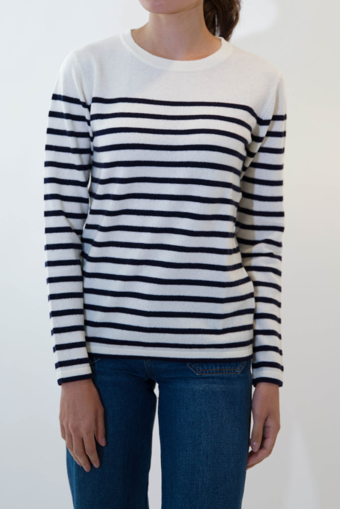 model wearing black and white striped april sweater on white background