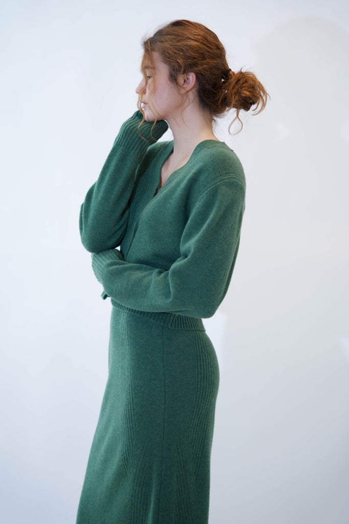 Side profile of woman wearing alicia cardigan on white background