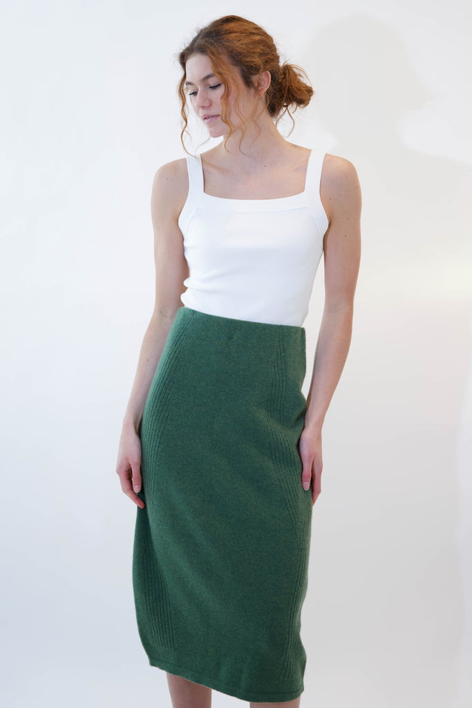 Woman wearing alicia green midi skirt on white background