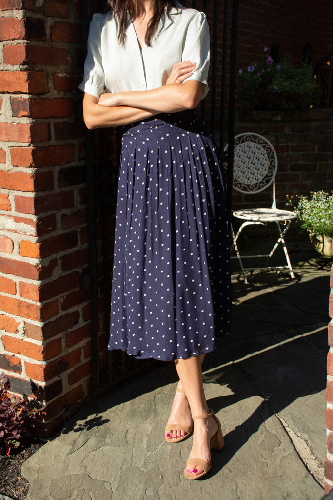 Woman wearing Skye navy polka dot skirt 