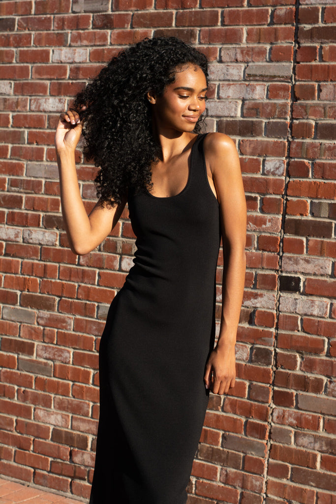 Woman wearing Tamira black sleeveless bodycon dress