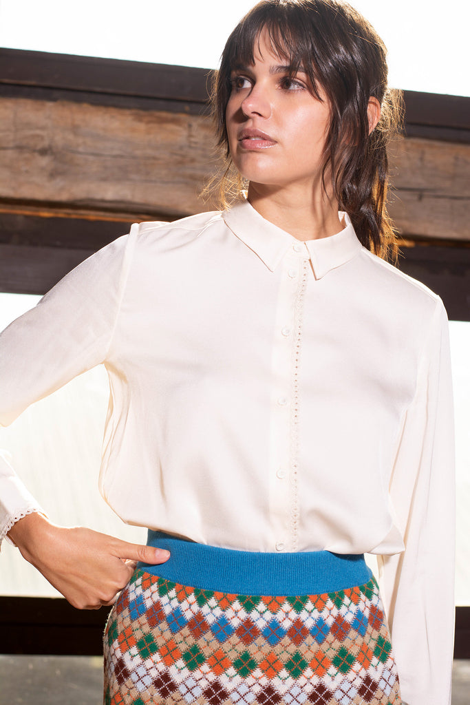 Woman wearing white Cara long sleeve blouse