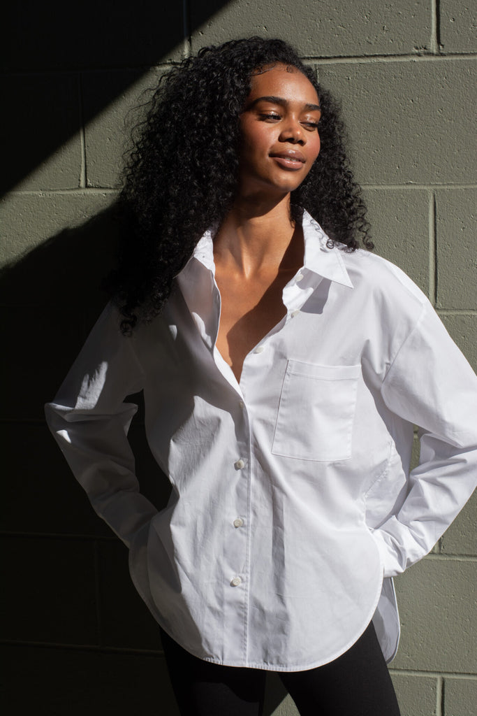 Woman wearing Ruthie white shirt with pocket 