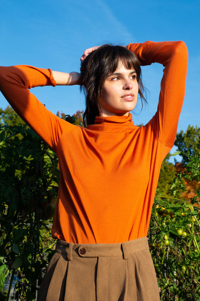 woman outside wearing kirstin orange turtleneck
