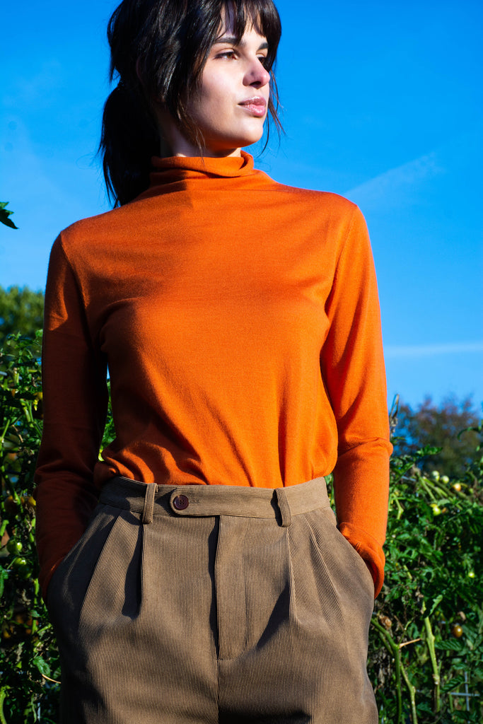 woman wearing kirsten orange turtleneck