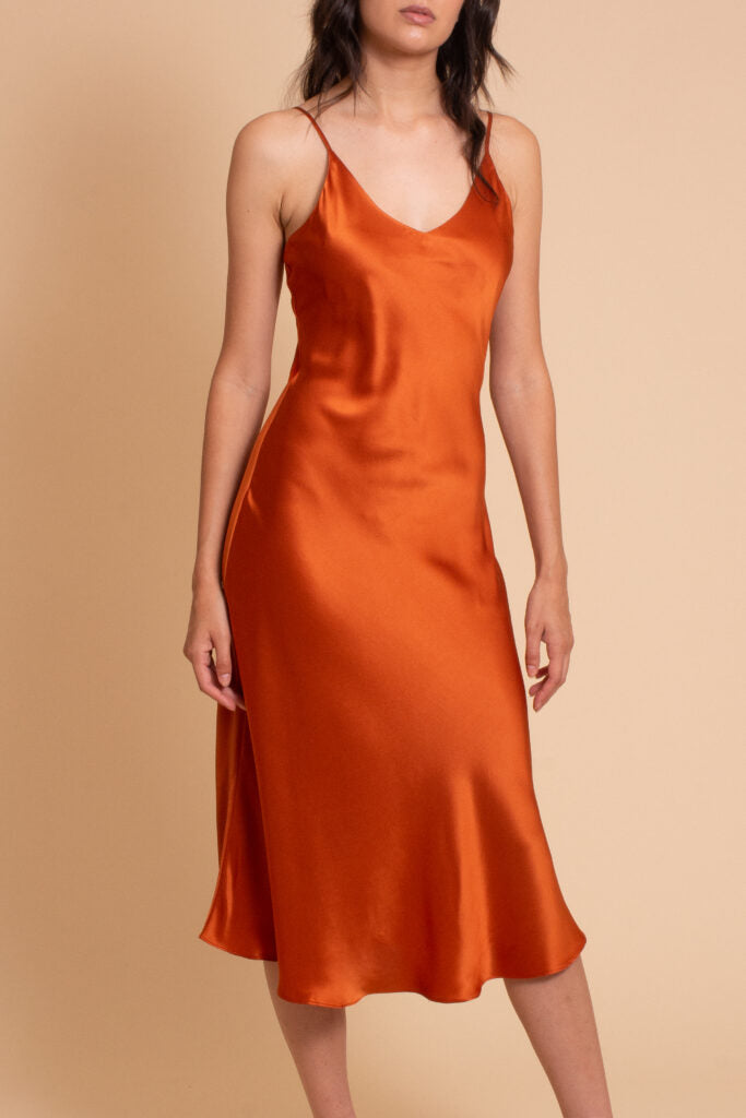 woman wearing orange summer midi dress