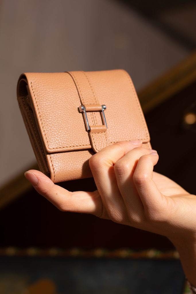 Hand holding full grain leather wallet