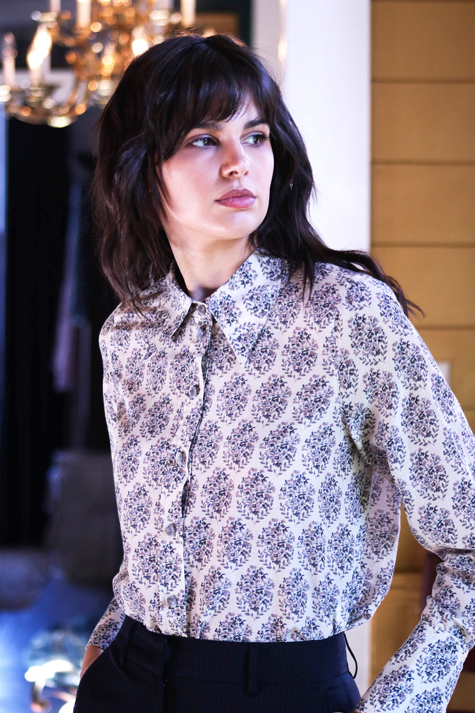 Woman wearing Sierra watercolor blouse 